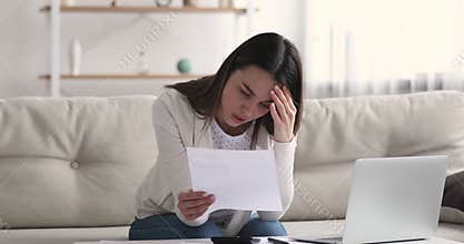 Worried stressed young woman upset by debt financial problem