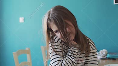 Beautiful school girl playing shy and looking positive indoors