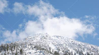 Clouds over snowy mountain