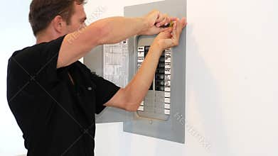 Electrician fixing electric panel in private home