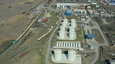 Flying on drone over modern grain storage facilities, agribusiness, farming in rural areas