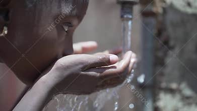 Portrait Close up of African Black Child Girl Drinking Fresh Water