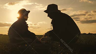 Family of farmers with box for vegetables harvesting crop on farm. Farming, gardening. Teamwork concept.