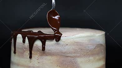 Cake decoration with chocolate icing. Slow motion