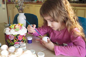 Little girl decorated eggs for Orthodox Easter during quarantine