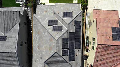 Aerial Top Down View Solar Panels on Rooftops in Residential Area, energy