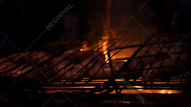 Grilling sausages on fire. Bavarian sausages.
