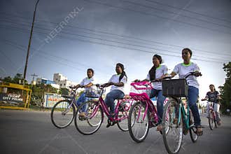 Low angle front view of young girls riding the bicycles for a cyclothon event