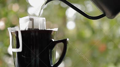 Coffee Drip Concept. Pouring Hot Water from Kettle into a Dripper.