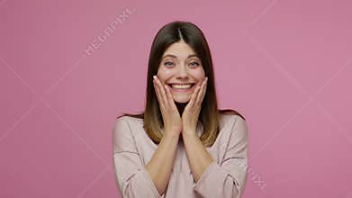 Extremely excited astonished brunette woman opening her mouth in amazement, looking joyful and surprised