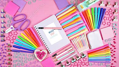 Back to school or workspace colorful stationery on pink flatlay stop motion.