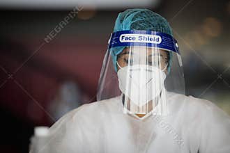Details with the face of a health official taking Covid-19 test, with mask and face shield