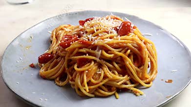grating parmesan cheese over pasta dish video