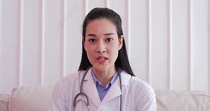 Beautiful female doctor talking to a patient in a video chat.