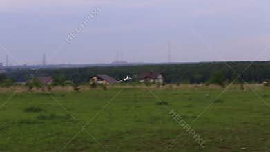 Aircraft model aerobatics over a green field