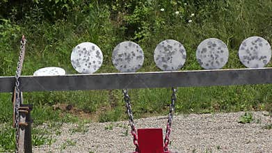 Metal Target at a shooting range being hit.