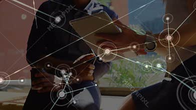Web of connections against man and woman using digital tablet