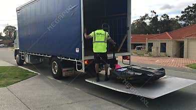 Truck driver loading cargo into a truck