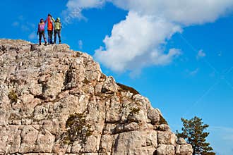 Team of hikers on the rocky summit