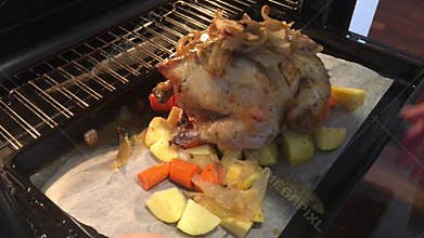 Roast chicken cooking in oven