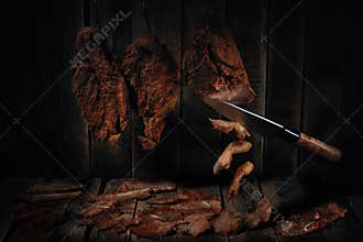 Homemade chicken breast basturma on a wooden background