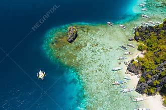Shimizu Island, El Nido, Palawan, Philippines. Beautiful aerial view of tourist boat on trip close to tropical island