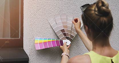 designer choosing paint color for house exterior facade