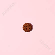 One piece gluten free chocolate protein energy bar cookie on pink background. Healthy vegan super food, fitness dieting snack,