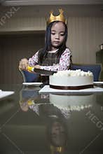 Little girl making birthday cake