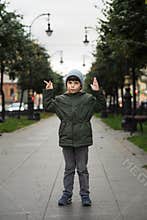 Portrait of a five-year-old boy in the city in the fall.