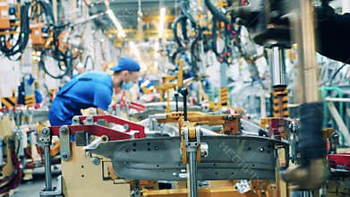 Spot welding of car part held in the car-making factory. Automobile factory, car production, auto production line.