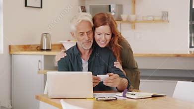 Wife embracing husband while working at home