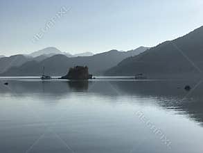 Scenic view of the calm sea in a bay with a fishing boat