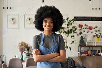 Happy African young woman cafe small business owner standing arms crossed.