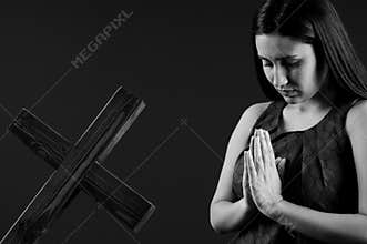 Young and beautiful woman praying