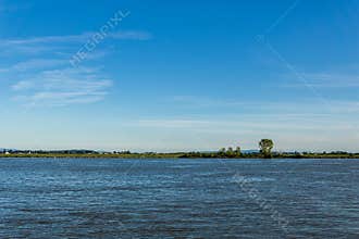 Afternoon time at the Fraser River seen from shore at in Richmond British Columbia Canada