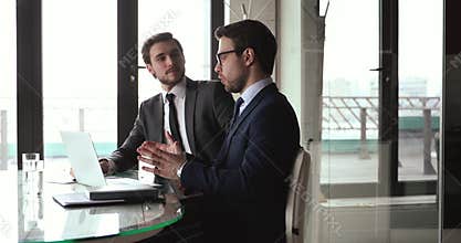 Financial advisor handshaking with client after presenting profitable offer.