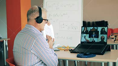 A teacher is showing formulas to adults students online