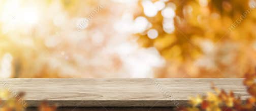 Autumn background.Empty old rustic wood table with blur forest tree with sunlight,Autumn fall backdrop, banner for product display