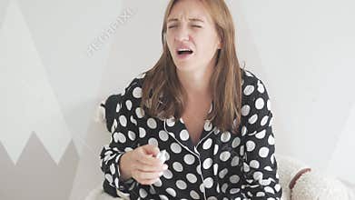 Woman with a Runny Nose Using a Nasal Spray