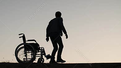 Man standing up from the wheelchair
