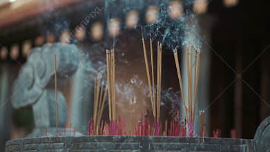 Incense sticks is burning in asian buddhist temple