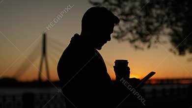 Silhouette of Young Man Drink Coffee .