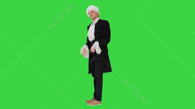 A man dressed as a courtier doing nothing and waving hands on a Green Screen, Chroma Key.