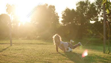 Childhood, games and entertainment, sports, physical culture, open air concept - little kid blonde girl play football on