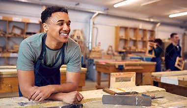Male Student Studying For Carpentry Apprenticeship At College