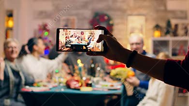 Girl taking a family portrait with her phones