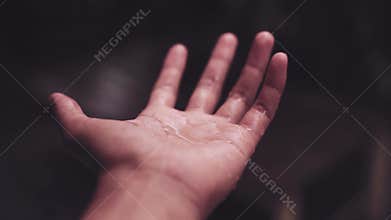 Close Up of water drops or falling rains drops on hand background with freshness environment season.
