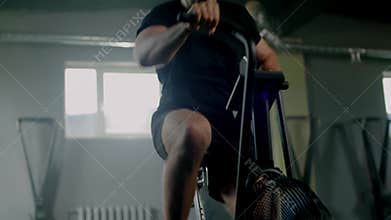 Active male have workout on stationary bike .