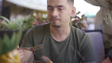Chernivtsi, Ukraine - aug 20 2019: man eat steak in restaurant with his girlfriend